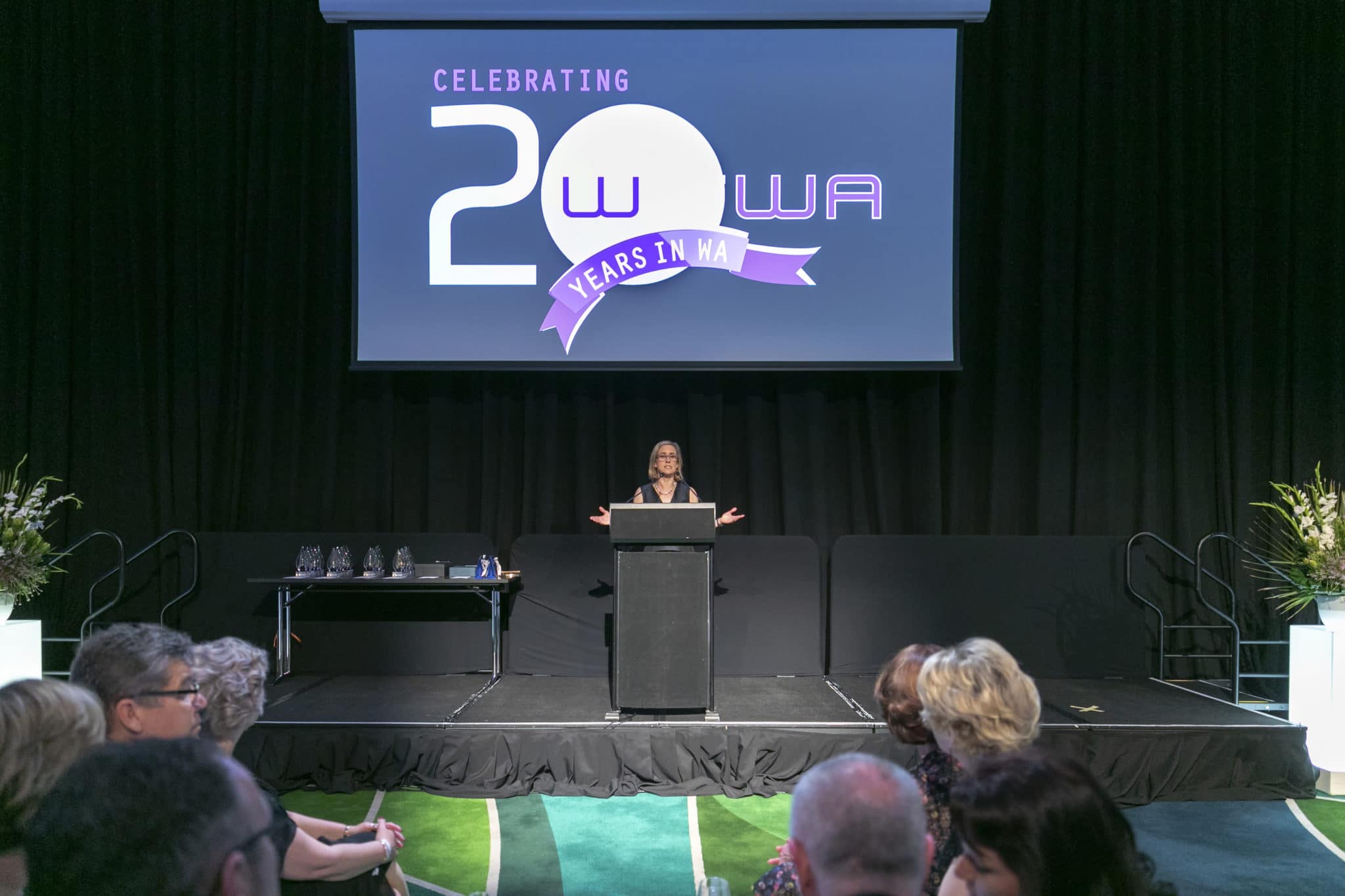 WiTWA 2018 20 in 20 Awards powerpoint slide with presenter standing behind a lecturn